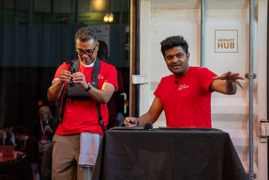 Vishal Rajpurohit walking hackathon participants through LaraCopilot from the Impact Hub stage.