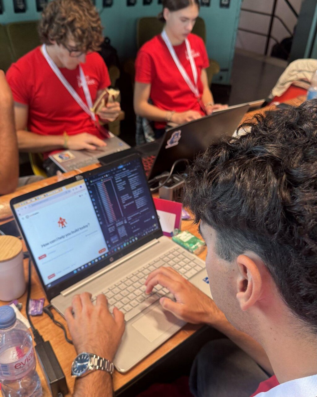 A hackathon participant starting a build in LaraCopilot on a laptop.