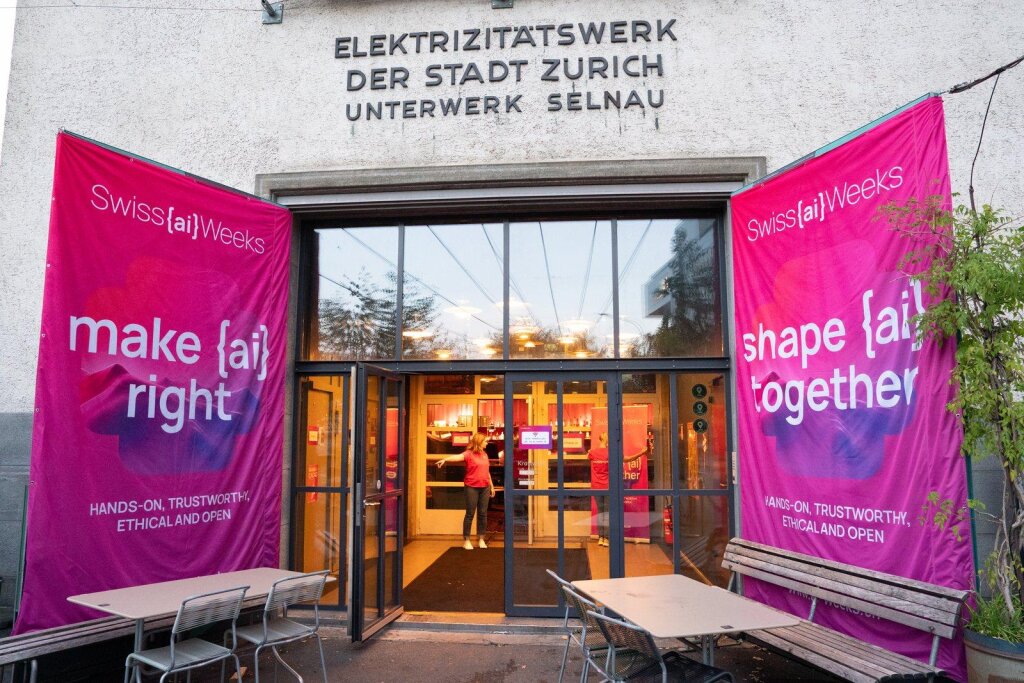 Kraftwerk Zürich's empty hackathon hall, set up with team tables and signage ahead of the 36-hour build.
