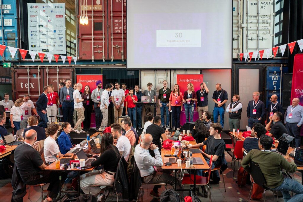 The Zurich Hackathon kickoff on stage at Kraftwerk Zürich, addressing the assembled teams.