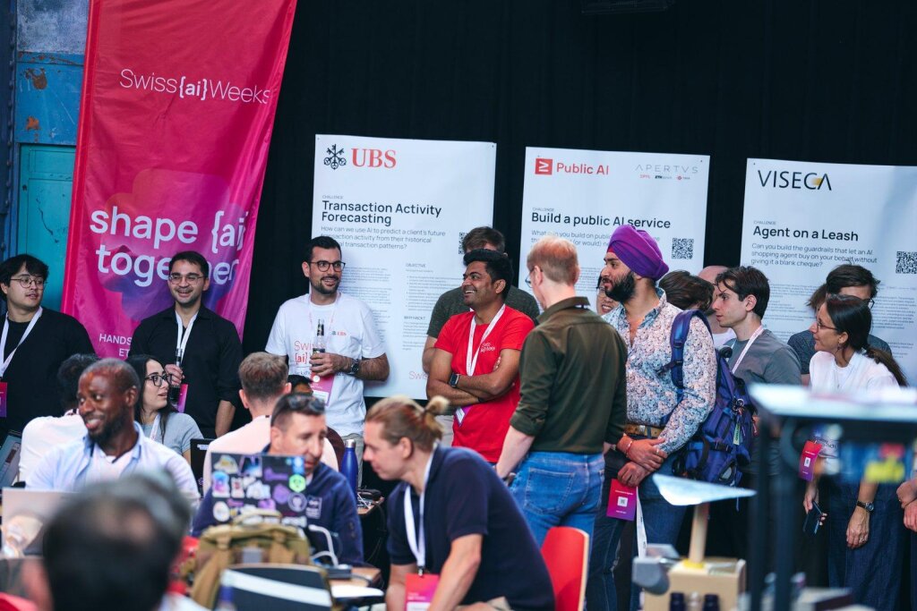 Hackathon participants reading the challenge posters before forming teams.