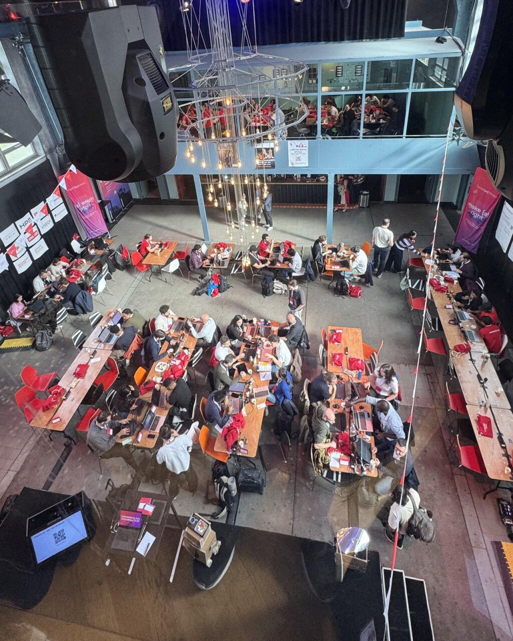 Kraftwerk Zürich filled with hackathon teams building at their tables.