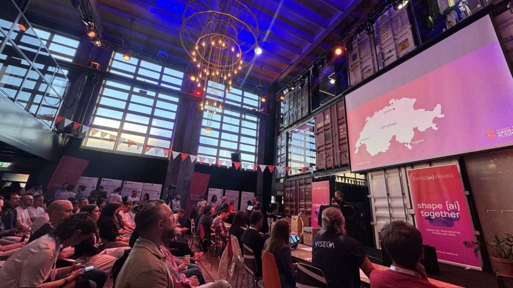 The main stage at Kraftwerk Zürich filling up as teams present their final pitches.